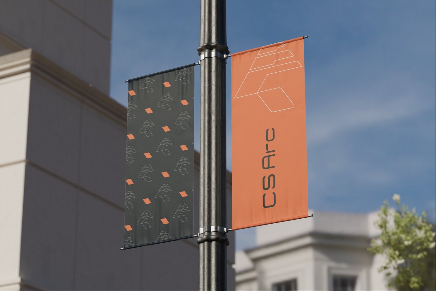 CS Arc street banners on a lamp post, one orange with the logo, one charcoal with a line-art pattern